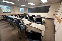 Front of room view with lectern on left in front of chalkboard