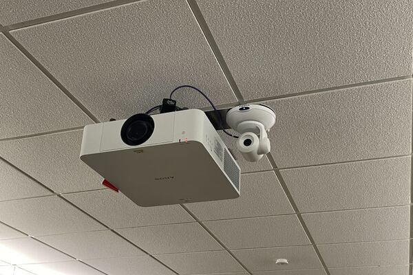 Camera mounted to ceiling and instructor enabled adjustments to the lens to allow the instructor to be "seen" by the camera in more locations around the room