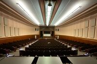 Front of room view with lectern on left in front of stage