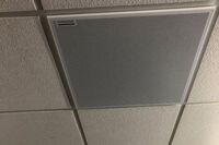 White 2¿ x 2¿ tile mounted in the ceiling to provide microphone coverage over student seating