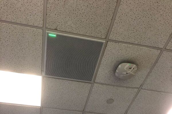 White 2¿ x 2¿ tile mounted in the ceiling to provide microphone coverage over student seating