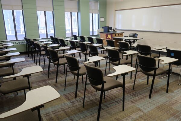 Front of room view with lectern on left in front of markerboard 