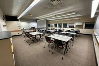 Front of room view with lectern on left in front of markerboard 