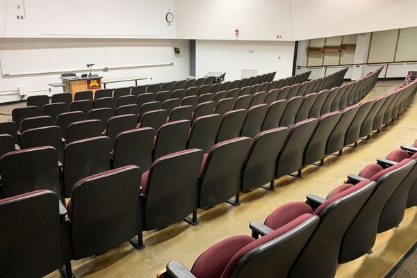 Front of room view with lectern on left in front of markerboard 