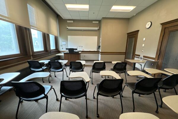 Front of room view with lectern on left in front of markerboard 