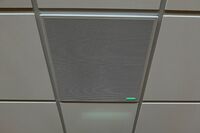 White 2¿ x 2¿ tile mounted in the ceiling to provide microphone coverage over student seating