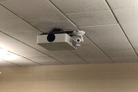 Camera mounted to ceiling and instructor enabled adjustments to the lens to allow the instructor to be "seen" by the camera in more locations around the room