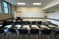 Front of room view with lectern on left in front of markerboard 