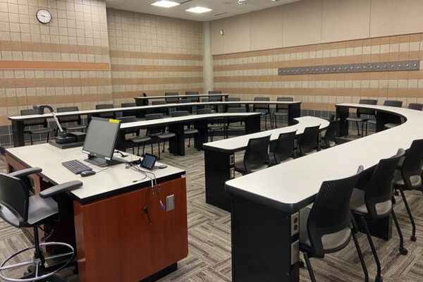 Back of room view of student tiered fixed-table and chair seating 