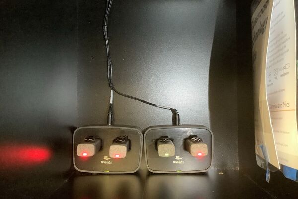 Pedestal - inside view of drawer showing wireless mics in charging base 