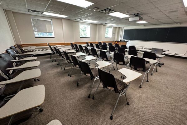 Front of room view with lectern on left in front of chalkboard