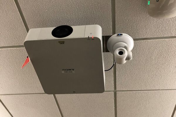 Camera mounted to ceiling and instructor enabled adjustments to the lens to allow the instructor to be "seen" by the camera in more locations around the room