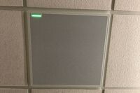 White 2¿ x 2¿ tile mounted in the ceiling to provide microphone coverage over student seating