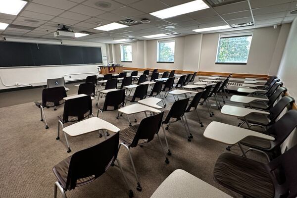 Front of room view with lectern on left in front of chalkboard