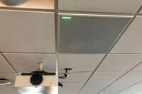 White 2¿ x 2¿ tile mounted in the ceiling to provide microphone coverage over student seating