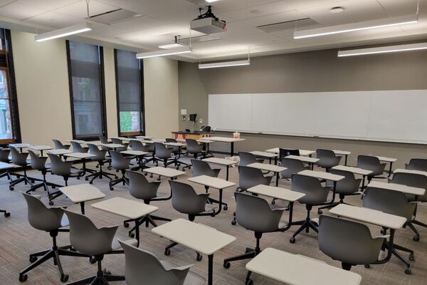 Front of room view with lectern on left in front of markerboard 