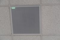 White 2¿ x 2¿ tile mounted in the ceiling to provide microphone coverage over student seating