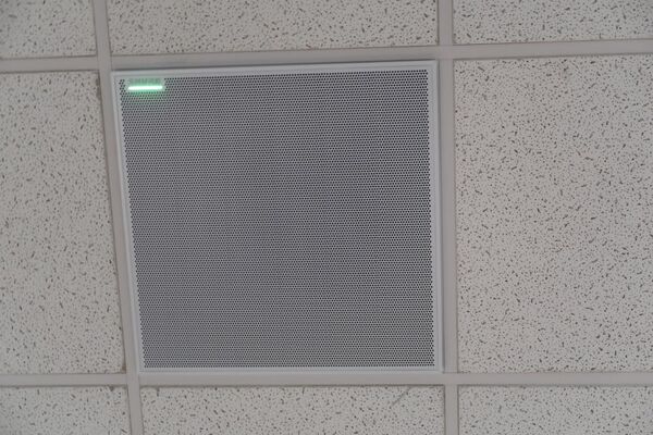 White 2¿ x 2¿ tile mounted in the ceiling to provide microphone coverage over student seating