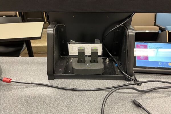 Pedestal - view of pocket showing two wireless mics in charging base