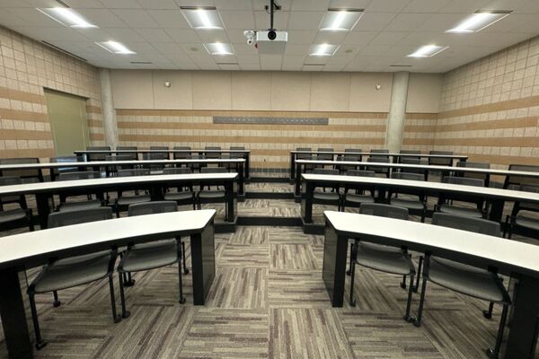 Back of room view of student tiered fixed-table and chair seating 