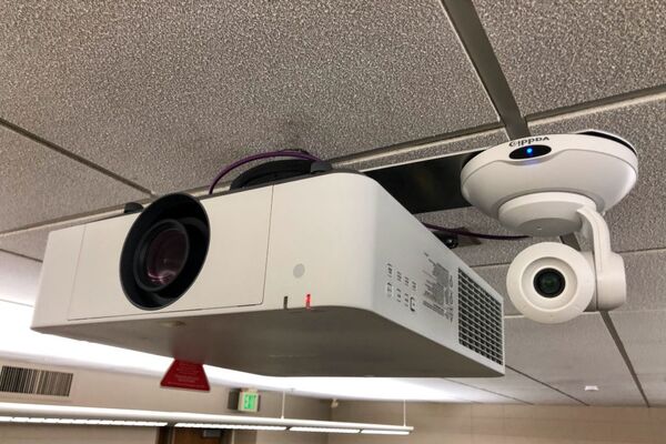 Camera mounted to ceiling and instructor enabled adjustments to the lens to allow the instructor to be "seen" by the camera in more locations around the room