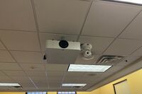 Camera mounted to ceiling and instructor enabled adjustments to the lens to allow the instructor to be "seen" by the camera in more locations around the room