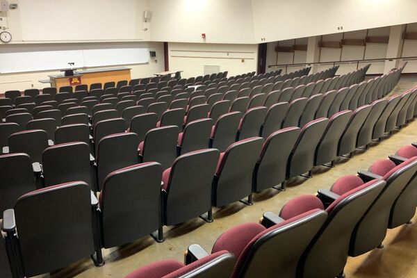 Front of room view with lectern on left, demonstration bench centered in front of markerboard 