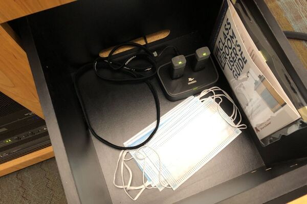 Pedestal - inside view of drawer showing two wireless mics in charging base