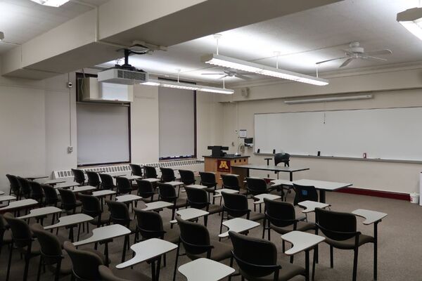 Front of room view with lectern on left in front of markerboard 