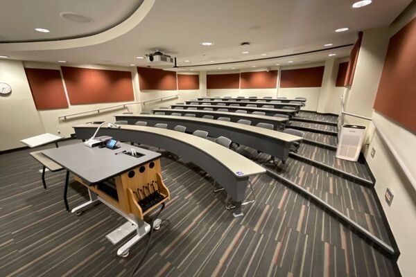 Back of room view of student tiered fixed table and chair seating 