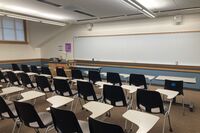 Front of room view with lectern on left in front of markerboard 