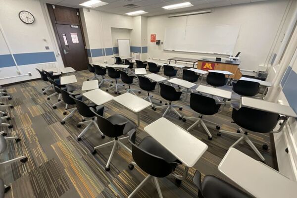 Front of room view with lectern on right in front of markerboard 