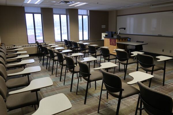 Front of room view with lectern on left in front of markerboard