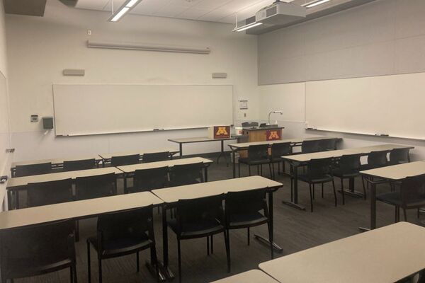 Front of room view with lectern on right in front of markerboard 