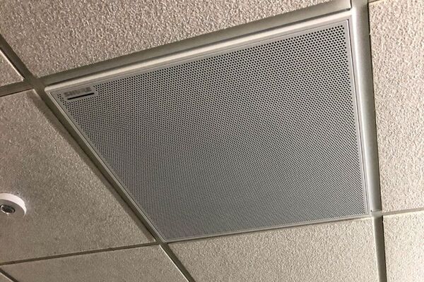 White 2¿ x 2¿ tile mounted in the ceiling to provide microphone coverage over student seating