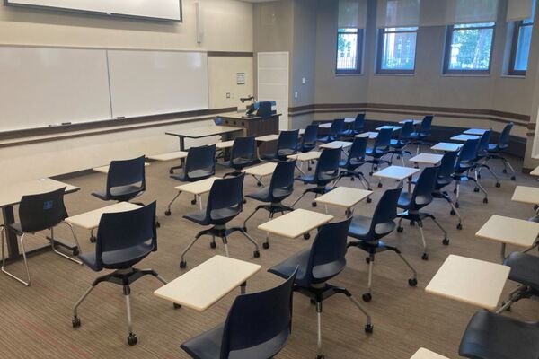 Front of room view with lectern on right in front of markerboard 