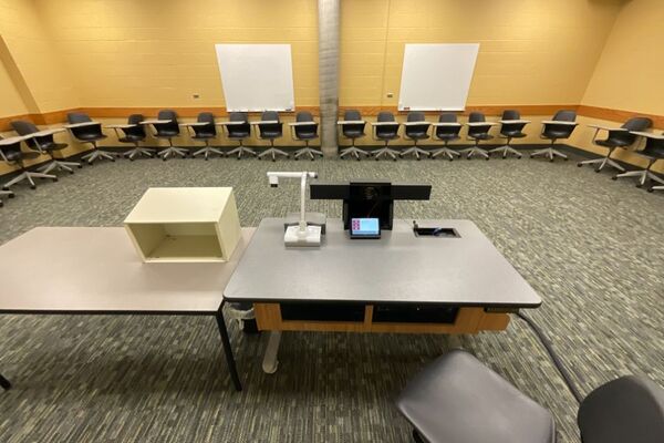 Back of room view of student tablet arm seating and markerboards on rear wall