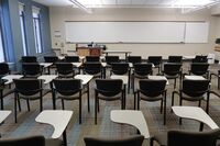 Front of room view with lectern on left in front of markerboard