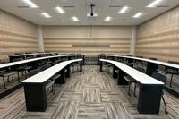 Back of room view of student tiered fixed-table and chair seating 