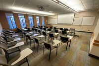 Front of room view with lectern on left in front of markerboard