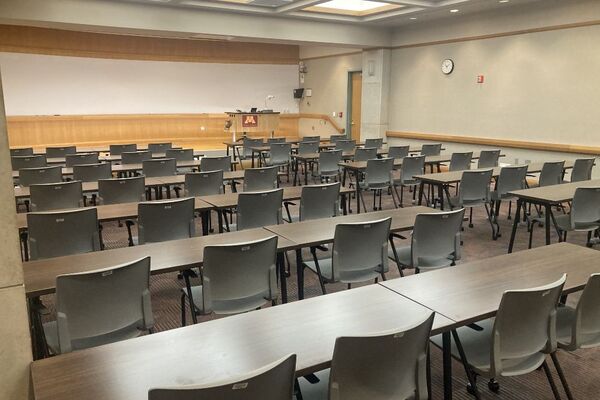 Photo of front of room from back of room, student table and chair seating  