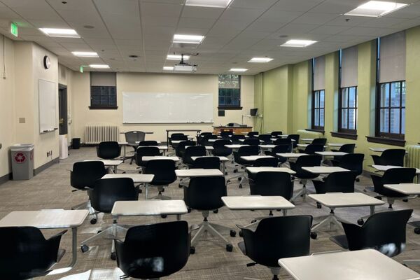 Front of room view with lectern on right in front of markerboard 