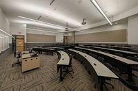 Back of room view of student tiered fixed-table and chair seating 