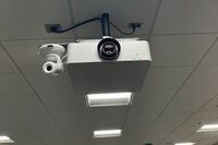 Camera mounted to ceiling and instructor enabled adjustments to the lens to allow the instructor to be "seen" by the camera in more locations around the room