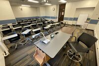 Back of room view of student tablet arm seating and camera on center of rear wall