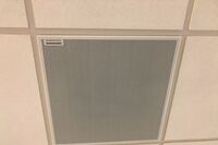 White 2¿ x 2¿ tile mounted in the ceiling to provide microphone coverage over student seating