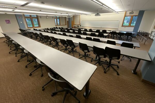 Front of room view with lectern on left in front of markerboard