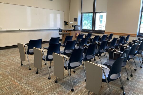 Front of room view with lectern on right in front of markerboard 