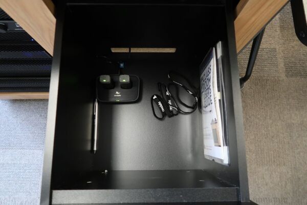 Pedestal - inside view of drawer showing two wireless mics in charging base