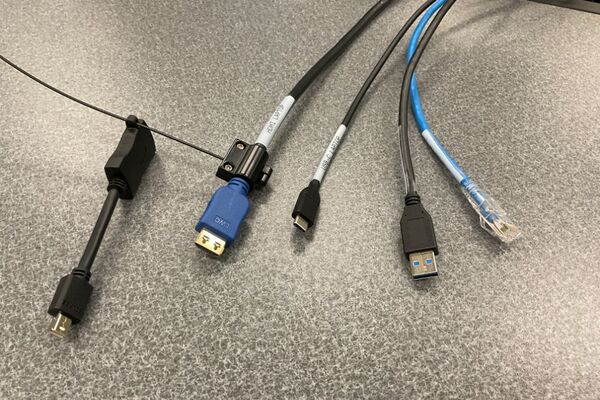 Pedestal - laptop cable connections with cables pulled out showing cable ends